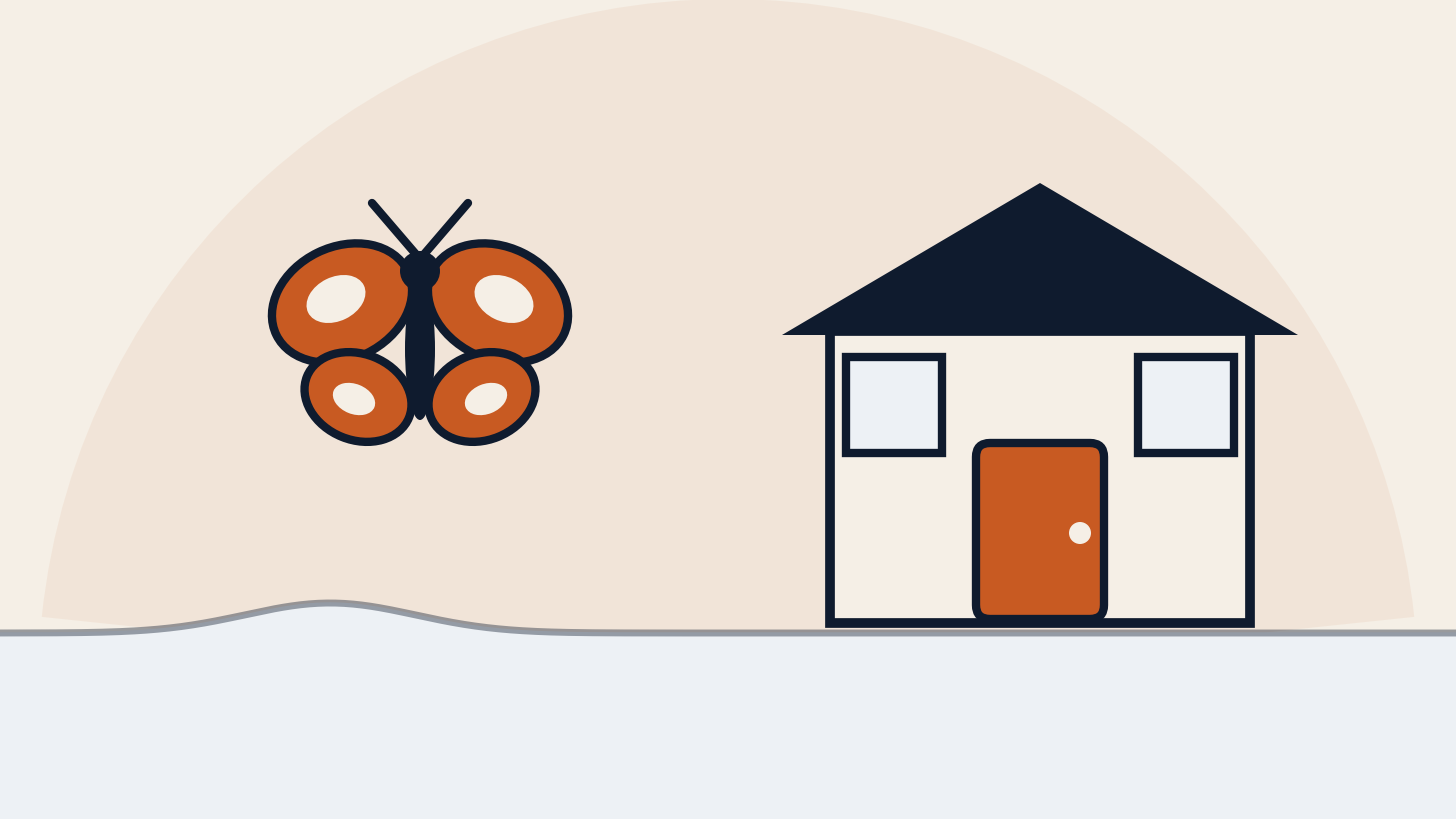 A monarch butterfly beside a small seaside cottage